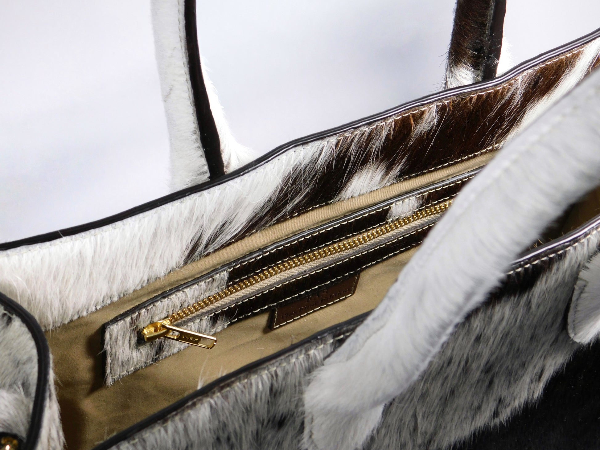 Interior shown for reference. Exterior hide varies by piece.